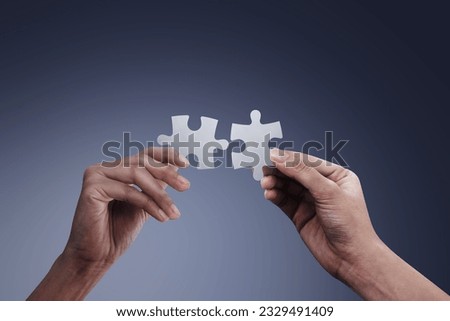 Hands holding jigsaw puzzles, business matching concept Royalty-Free Stock Photo #2329491409