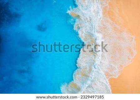 Coast as a background from top view.  Waves and beach. Aerial landscape. Azure water background from drone. Summer seascape from air. Vacation time.