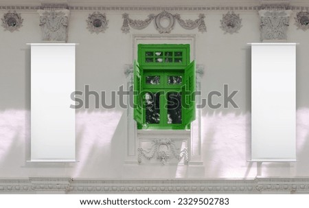 Blank vertical hanging banners on white walls of old shop house front — advertising mockup template. Light and shadow on the walls, green window framed with architectural details.