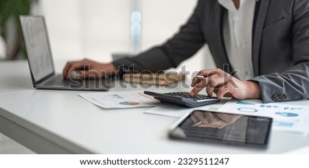 Young asian business man audit analysis graph company budget report, assigned accounts receivable, production control, operational audit, cost plus pricing Royalty-Free Stock Photo #2329511247