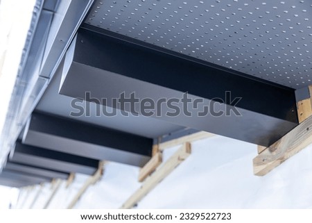 Sheet metal winding of outer girders at a new house construction site Royalty-Free Stock Photo #2329522723