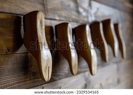 Shoe pads hang on a wooden wall. High quality photo