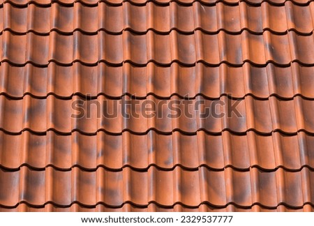 Red tiles roof background texture of a house
