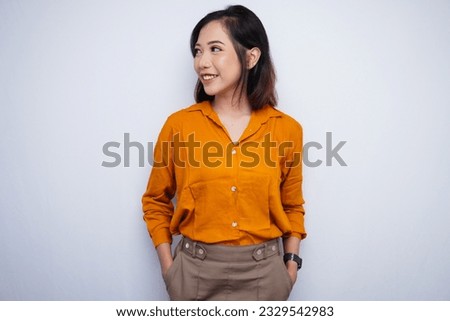 Asian Woman Looking Sideways in Office Royalty-Free Stock Photo #2329542983