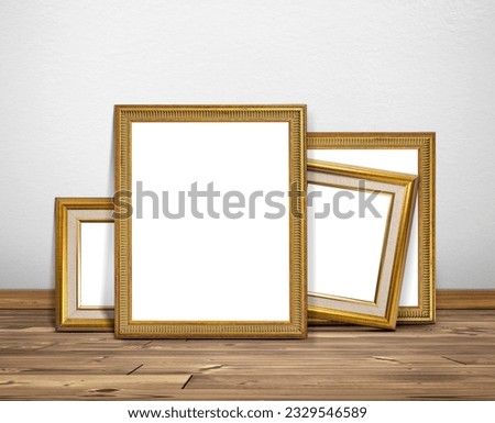 Golden picture frame in room white walls and wooden floors