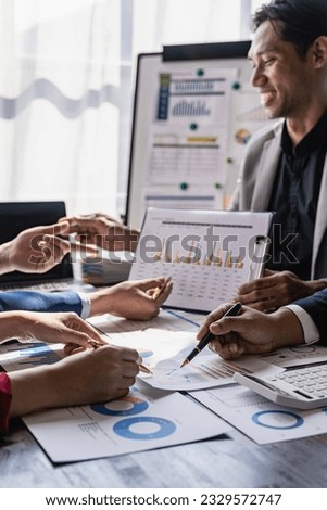 Businessman discussing work on paper SEO data graph chart on laptop Asian man and woman share career idea about project budget report in meeting in office Royalty-Free Stock Photo #2329572747