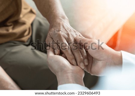 Parkinson disease patient, Alzheimer elderly senior, Arthritis person's hand in support of geriatric doctor or nursing caregiver, for disability awareness day, ageing society care service Royalty-Free Stock Photo #2329606493