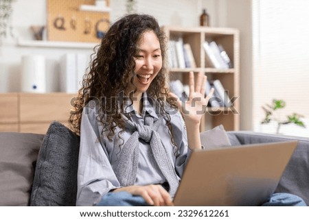 Long Curly hair woman doing online video chat call record vlog blog talking to camera looking at webcam indoors at home office, video call and social media concept. Royalty-Free Stock Photo #2329612261