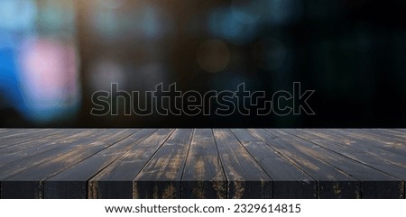 Empty wooden tebletop with bokeh light on blurred restaurant backgrounds