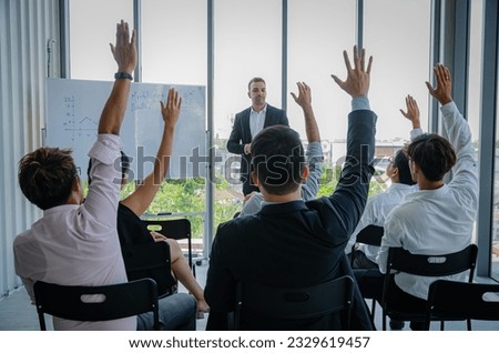 Head of Business Training Sales and Marketing Teams.Male employee raising his hand to ask boss.Many people sat and listened to seminar. Royalty-Free Stock Photo #2329619457