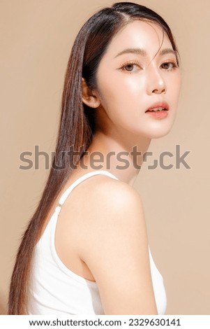 Young Asian beauty woman model long hair with korean makeup style on face and perfect skin on isolated beige background. Facial treatment, Cosmetology, Spa, Aesthetic, plastic surgery. Royalty-Free Stock Photo #2329630141