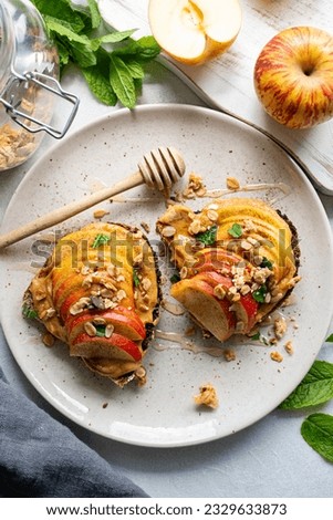 Toasts with peanut butter, apples and honey. Healthy breakfast food or snack. Royalty-Free Stock Photo #2329633873