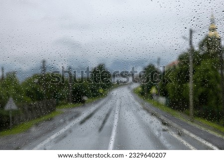 the windshield of a bus or car is wet after rain. Road view. journey. Road in the rain. Path into the unknown. Horizontal.