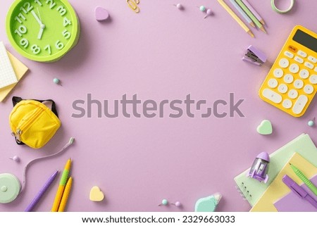 Explore the world of learning through this creative above view picture showcasing notepads, calculator and other school supplies on an isolated light green backdrop. Perfect for text or advertising