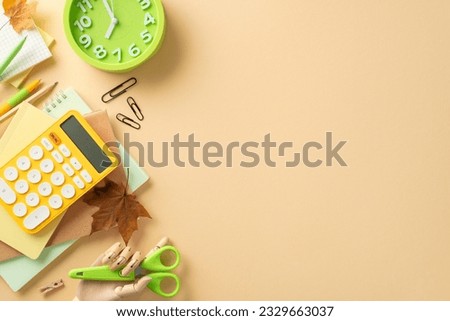 Embrace the fresh start of the academic year with this captivating high-angle picture displaying colorful collection of school supplies on beige background. The copy-space invites text or promotion