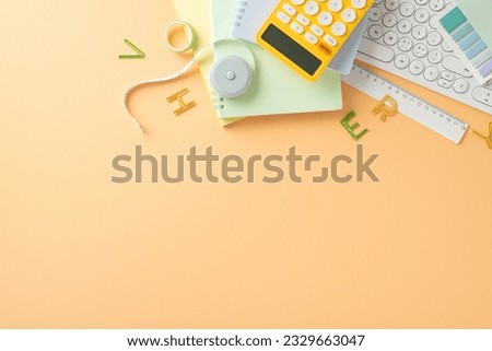 Ready for knowledge. Overhead shot of stationery, ruler, calculator, computer keyboard, and other school items on pastel orange background. Customize vacant area for your back-to-school promotion