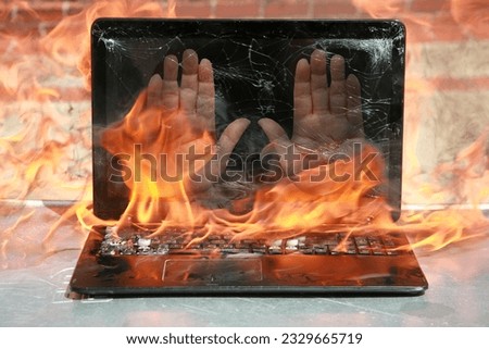 Burning laptop. Human Hands on a Computer Monitor. It's hot in here. Hell Fire. Setting the world on fire. Laptop burning in flames. Fire hazard. Losing valuable data. Laptop Damage. Computer on Fire 