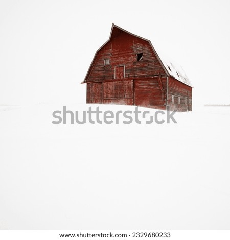 Red barn in winter landscape.