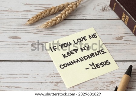 If you love Me, keep My commandments, Jesus Christ's words written in holy bible book with ripe wheat on wooden table. Close-up. Christian disciples obedience and faith in God, biblical concept. Royalty-Free Stock Photo #2329681829