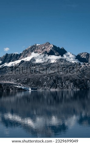 image showing a large lake bordered by a snowy mountain to use as a wallpaper.