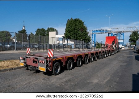 Transport, an unusual semi-trailer for transporting special loads with a tractor unit Royalty-Free Stock Photo #2329705261