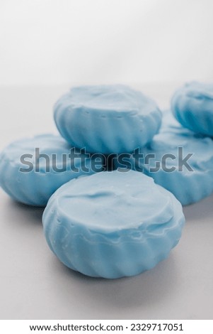 Handmade light blue soap with flowers on fabric, close-up