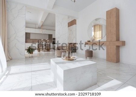 light luxury interior design of a modern apartment in a minimalist style with marble trim and huge windows. daylight inside the kitchen and living room Royalty-Free Stock Photo #2329718109