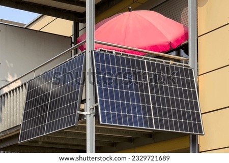 Solar battery on balcony wall of modern house in Germany, closeup. Balcony Mini photovoltaic power plant. Mini PV plants generate your own electricity plug play. Small Solar Panel energy system.  Royalty-Free Stock Photo #2329721689