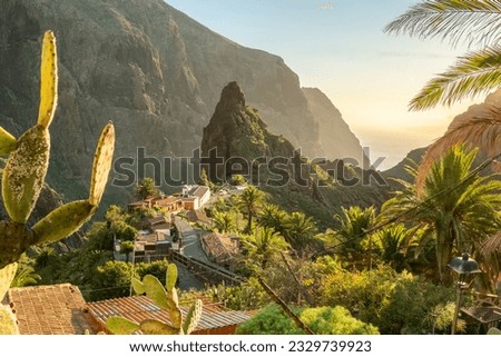 Landscape of the Masca valley at sunset in Tenerife, Canary island, Spain. Scenic mountain landscape with palm trees and tropical vegetation in Tenerife. Royalty-Free Stock Photo #2329739923