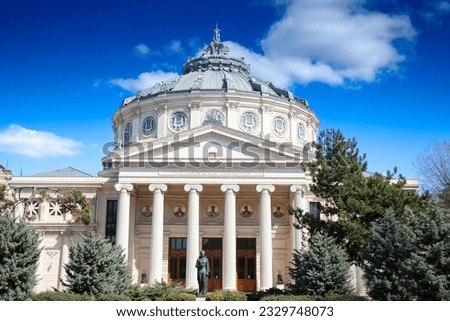 Ateneul Roman main facade in front of a park during a sunny afternoon. with the mention Ateneul Roman meaning in Romanian Athenaeum. It is a concert hall and venue, a major landmark of Bucharest. Royalty-Free Stock Photo #2329748073
