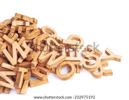 Pile of wooden block letters isolated over the white background as a typography background composition