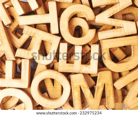 Surface covered with multiple wooden letters as a typography background composition