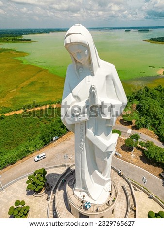 Beautiful morning at Nui Cui Mountain. Top view of Our lady of Lourdes Virgin Mary catholic religious statue on a Nui Cui mountain. Travel and religion concept. Royalty-Free Stock Photo #2329765627