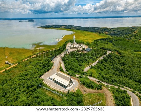 Beautiful morning at Nui Cui Mountain. Top view of Our lady of Lourdes Virgin Mary catholic religious statue on a Nui Cui mountain. Travel and religion concept.