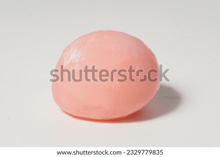 Close up of smooth silky pink mochi with white background. 
