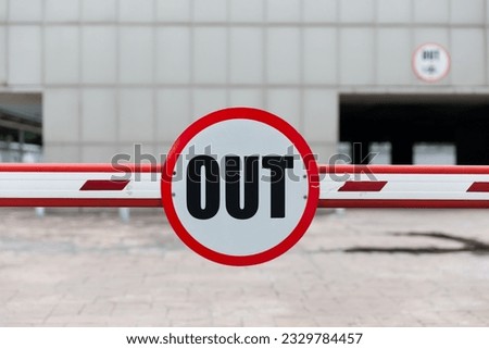 Red and white car barrier out and in or entrance and exit way blur building background 