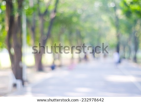 Blurry background, Blur street, road in nature outdoor with bokeh light background, Blurry people running on street, road at green tree park garden nature in spring and summer backdrop, banner, poster