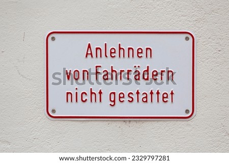 Sign leaning on bicycles not allowed on a house wall, Germany