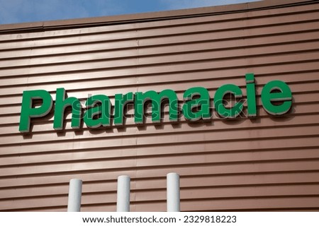 pharmacie lighting logo sign text in french means on wall building shop pharmacy facade