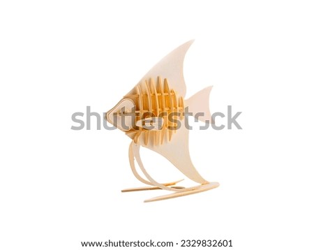 Miniature angel fish animal made of wood isolated on white