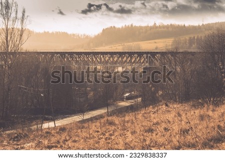 Railway bridge in Owl Mountains during sunset in winter