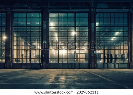 exterior of big old warehouse with windows at night Royalty-Free Stock Photo #2329862111