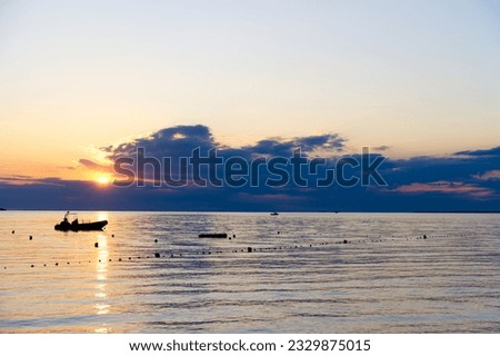 Rubber small boat anchored at sunset calm at sea relax vacation