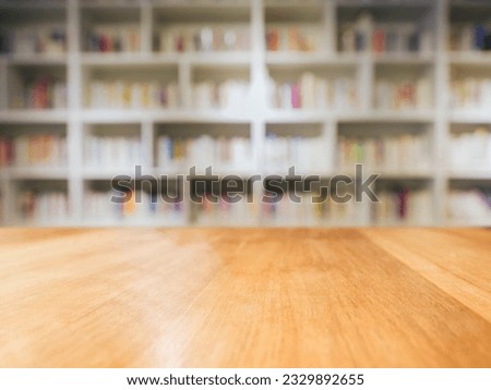 Table top wooden Counter with Blurred Book shelf interior background