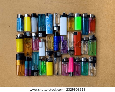 Close Up View of Colorful Lighters, Plastic Waste Trash, Used Multi Colored Gas Lighters in Different Shapes, Types  and Brands, Flat Lay, Top View