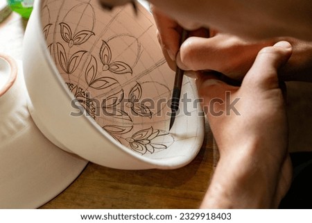 a man drawing in a bowl