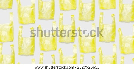 Top view pattern from Yellow plastic bags, wide banner. Single-use empty polythene packet, Eco trend to reduce disposable plastics, Biodegradable packaging waste, creative pattern as design background