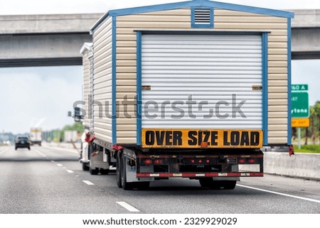 Oversize over size load hauler truck trailer vehicle hauling mobile module home house on North Carolina interstate highway road Royalty-Free Stock Photo #2329929029