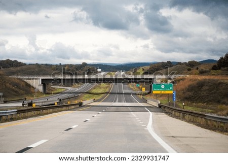Moorefield, West Virginia Allegheny mountains driving with exit sign car point of view on road to Dolly Sods with cars in traffic on highway and overcast cloudy mist fog sky weather Royalty-Free Stock Photo #2329931747