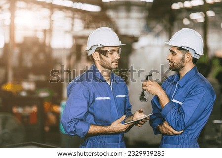 engineer worker male hispanic indian male teamwork happy working together in heavy metal industry steel lathe CNC factory Royalty-Free Stock Photo #2329939285